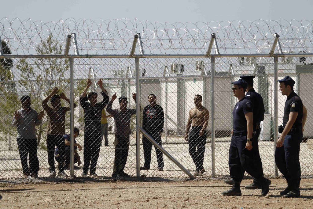 Police officers patrol a detention centre for immigrants in the Amygdaleza suburb in Athens